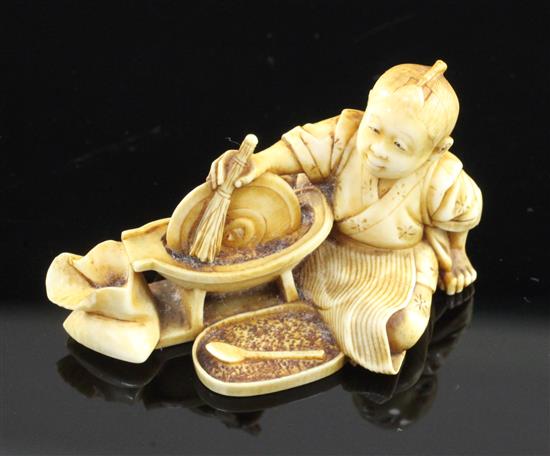 A Japanese ivory netsuke of a boy grinding seed?, Meiji period, 5.1cm